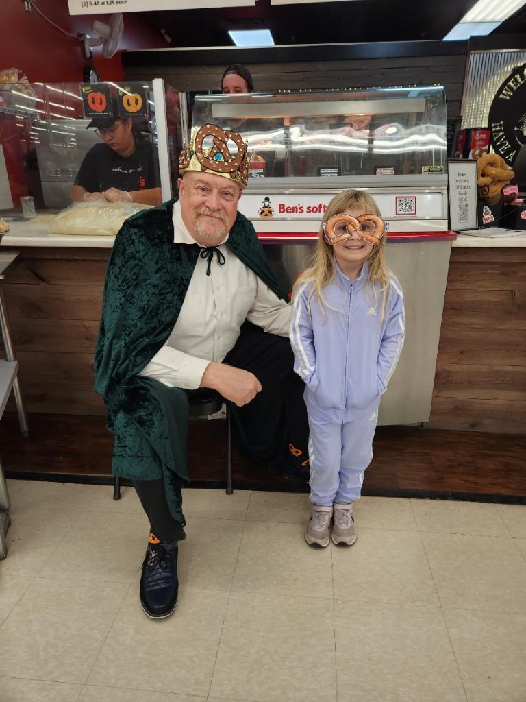 PK kneeling with a kid at the store